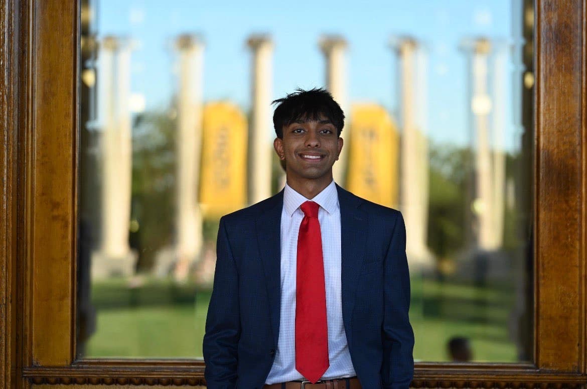 Portrait of Neer Patel, Co-Founder of Atlas Health Equity Group, smiling outdoors on the University of Missouri campus.
